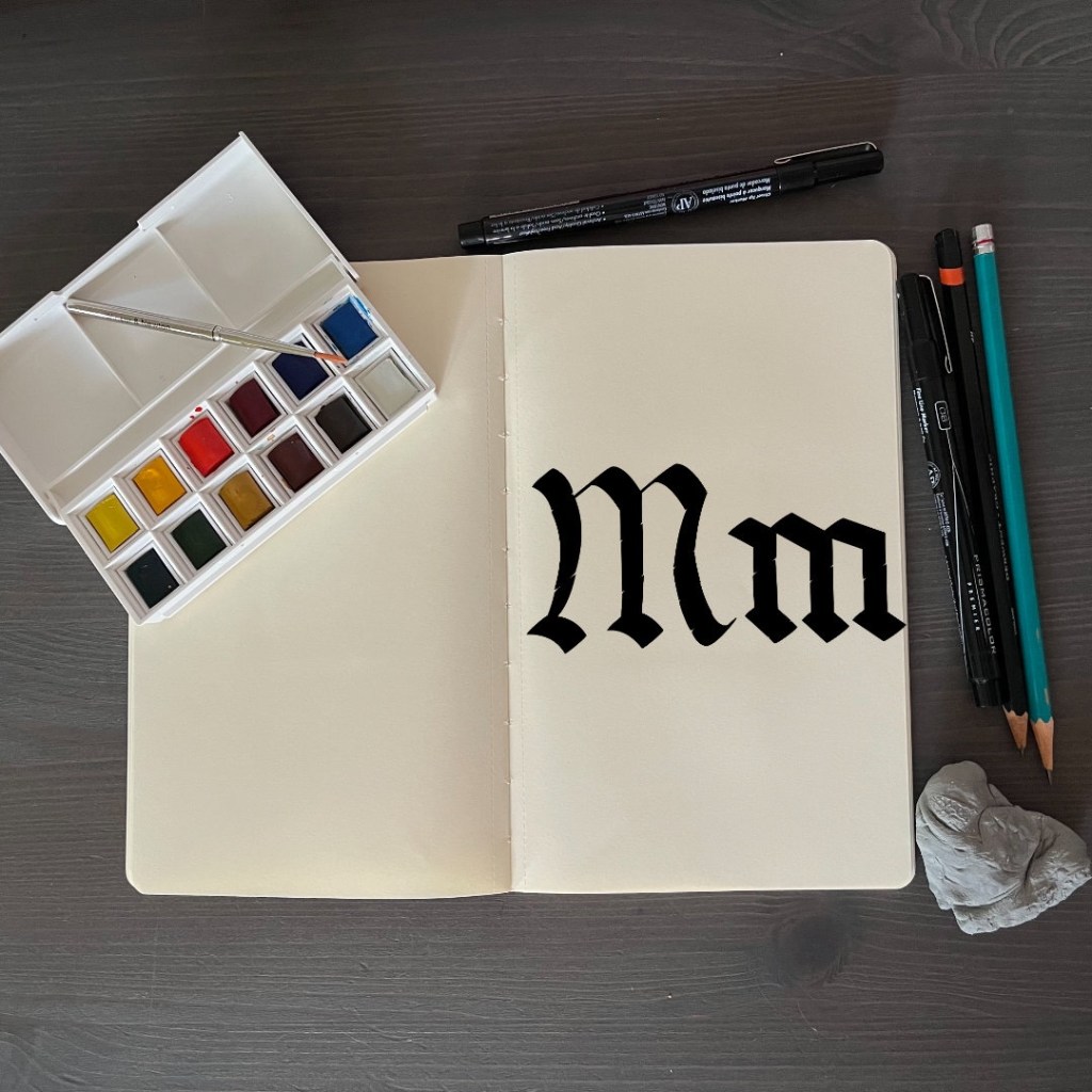 the letter Mm with an artsy background for 36 days of type