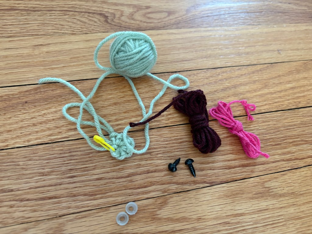 Yarn, safety eyes, started piece with stitch marker to make a small fun piece for the kids.