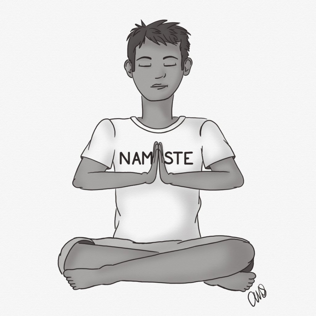 Young man sitting cross-legged with eyes closed in meditation. His shirt says namaste but is blocked by his hands.